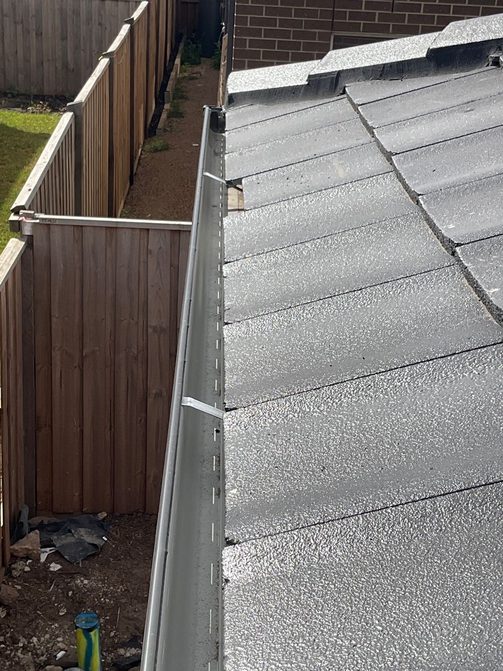 Roof tile sitting out of position, a slip and leak risk, Sunbury