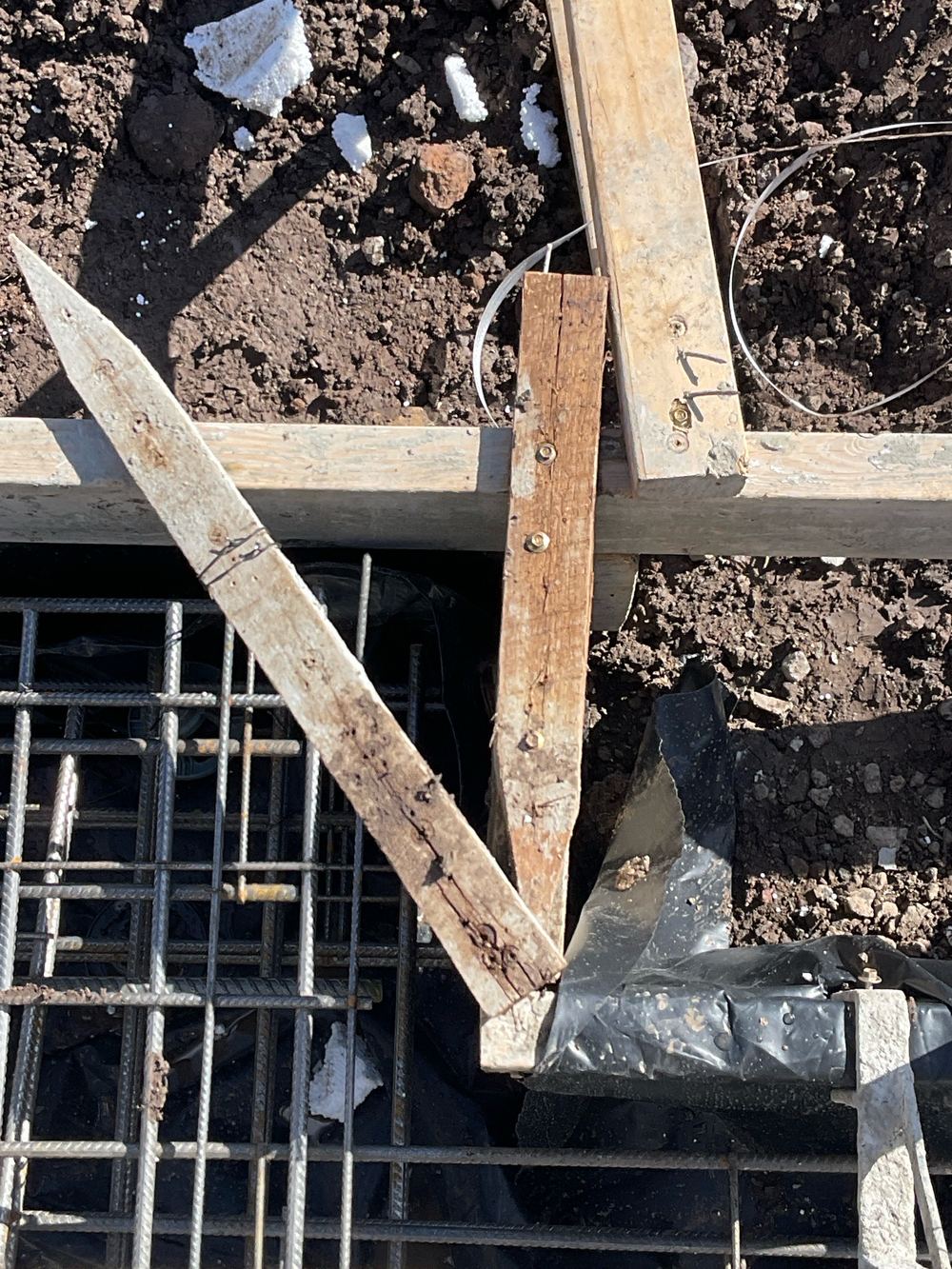 Vapour barrier draped over the reinforcement instead of lying beneath it, found during a slab pre-pour inspection in Sunbury